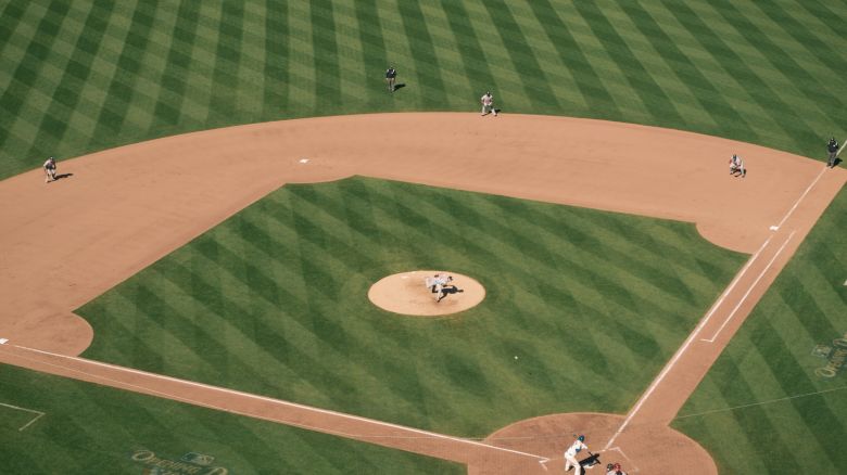 An aerial view of a baseball field during a game, with players positioned on the field and the batter at home plate.